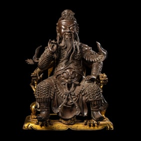 A Chinese Ming Dynasty gilt bronze statue of Guan Yu.