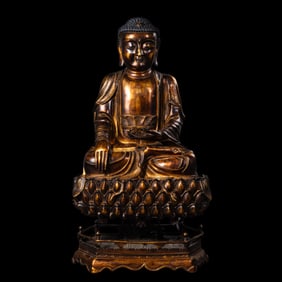 A Chinese Ming Dynasty gilt bronze statue of a seated Buddha