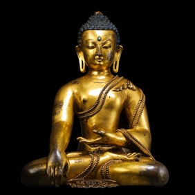 A Chinese Ming Dynasty gilt bronze statue of a seated Buddha