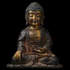 A Chinese Ming Dynasty gilt-bronze statue of seated Sakyamuni Buddha