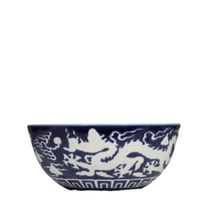 A Chinese Ming Xuande period blue-glazed bowl with white dragon design