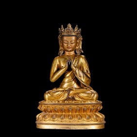 A Chinese Ming Dynasty gilt bronze statue of a seated Buddha