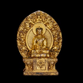A Chinese Ming Dynasty gilt bronze statue of a seated Buddha
