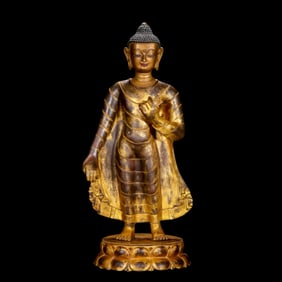 A Chinese Ming Dynasty gilt bronze standing Buddha statue