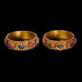 A pair of West Asian gemstone-encrusted pure gold bracelets