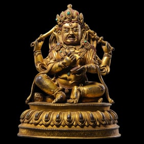 A 15th-century Tibetan Buddhist four-armed yellow Jambhala statue