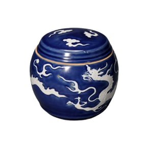 A Yuan Dynasty Chinese celadon-glazed covered jar with a white dragon design.