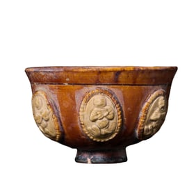 Small yellow-glazed cup with applied decoration from the Sui Dynasty of China