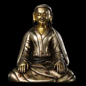 A Qing Dynasty gilt bronze and silver-plated seated Guru Buddha statue