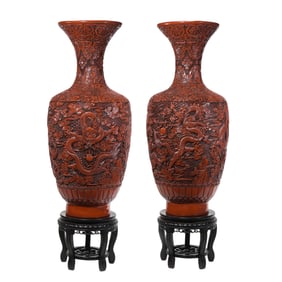 A pair of Chinese Qing Dynasty carved red lacquer dragon-patterned appreciation vases