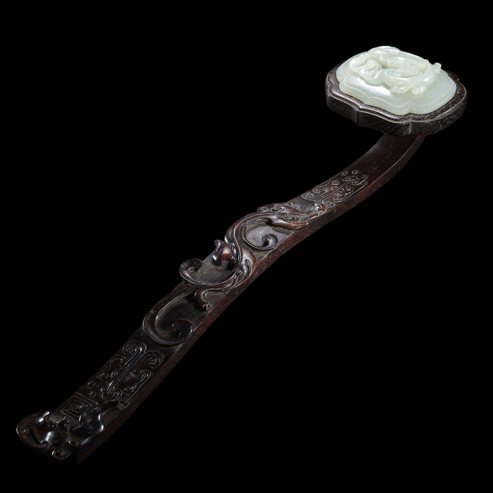 A Qing Dynasty rosewood ruyi inlaid with Hetian jade (1 of 14)