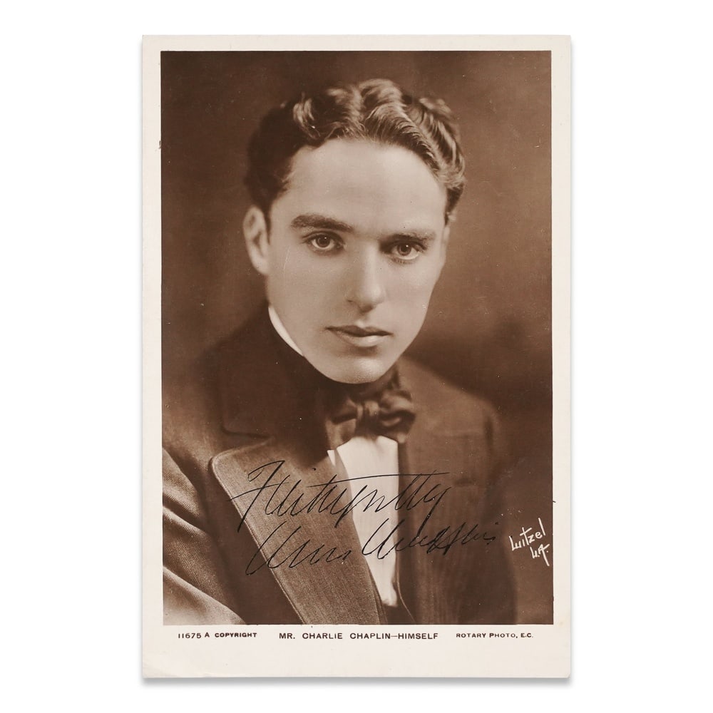 CHARLIE CHAPLIN SIGNED REAL PHOTO POSTCARD: 5 3/8 x 3 1/2 in (13.8 x 9 cm) Provenance and Authentication: This collectible has undergone a rigorous forensic evaluation. The signatures were carefully analyzed across multiple criteria, including