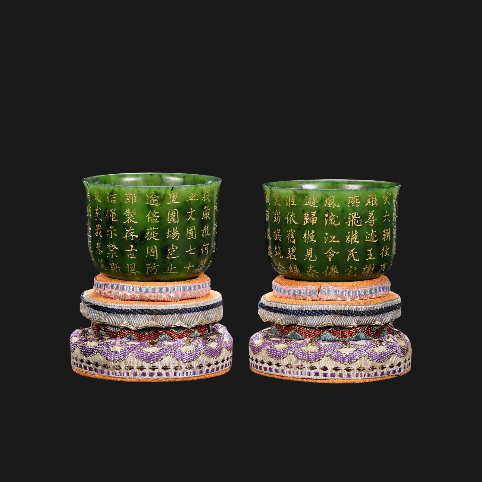 A pair of Qing Dynasty Hetian jade cups with gold-painted inscriptions: H. 3.4 cm. W. 5.5 cm. Weight 150 gram.