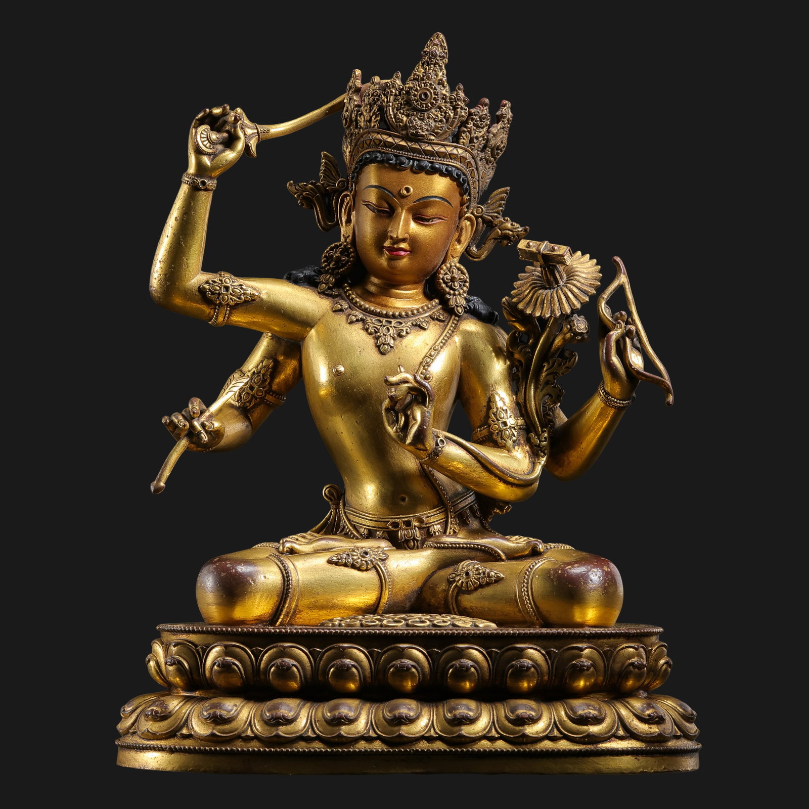 18th-century Nepalese Late Malla period gilt bronze four-armed Manjushri Bodhisattva: H. 20.5 cm. W. 16 cm. Weight 2054 gram.