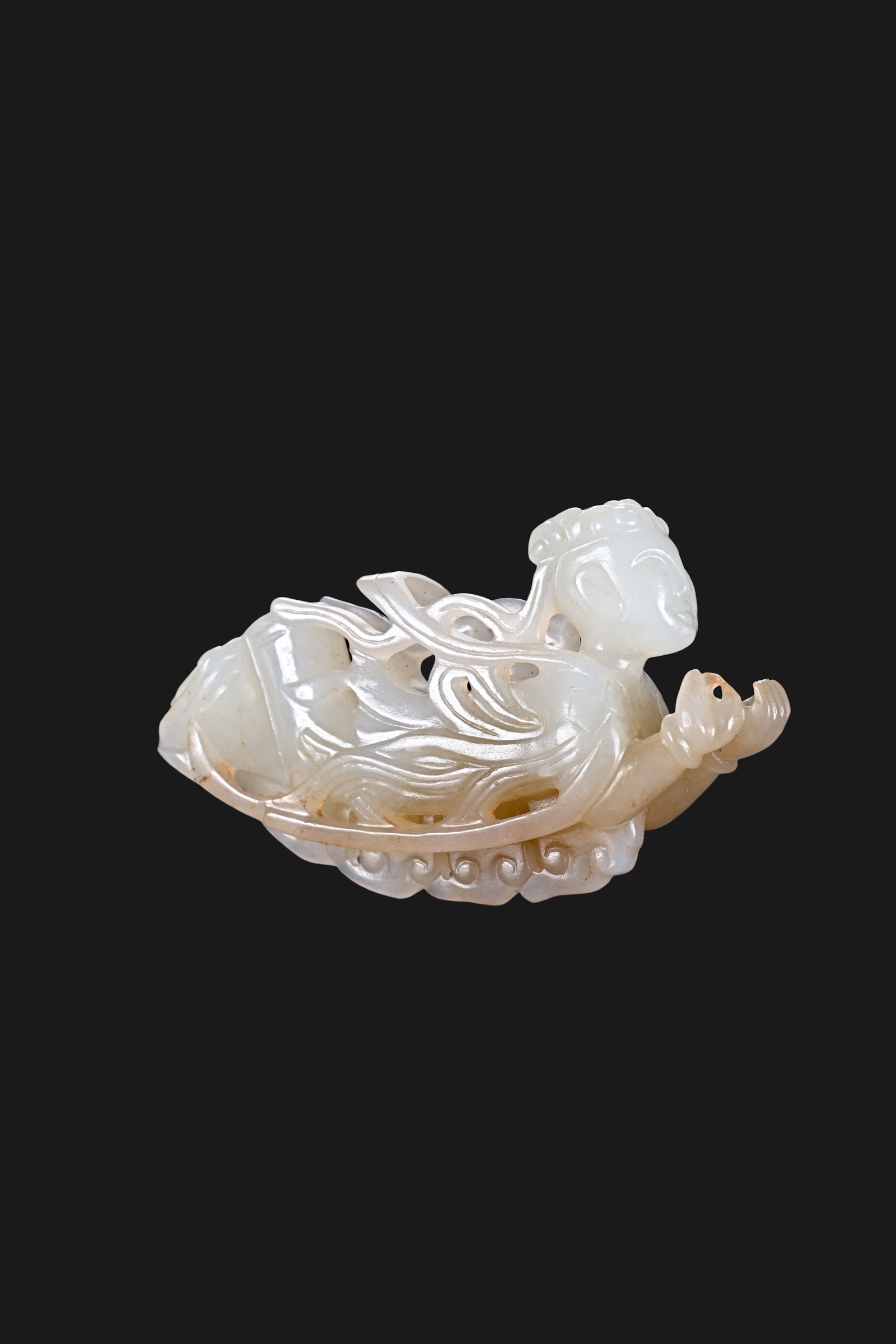 Chinese Liao Dynasty White Jade Openwork Flying Apsara Pendant: L. 7.3 cm. W. 4.2 cm. Weight 45.5 gram.