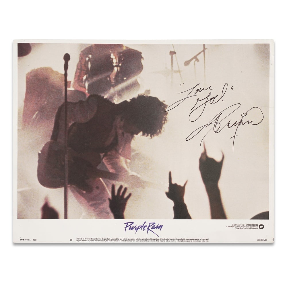 PRINCE SIGNED "PURPLE RAIN" ORIGINAL 1984 LOBBY CARD: 14 x 11 in (35.5 x 28 cm) Provenance and Authentication: According to the Letter of Authenticity (LOA) and Certificate of Authenticity (COA) provided by the consignor, this collectible was subjected