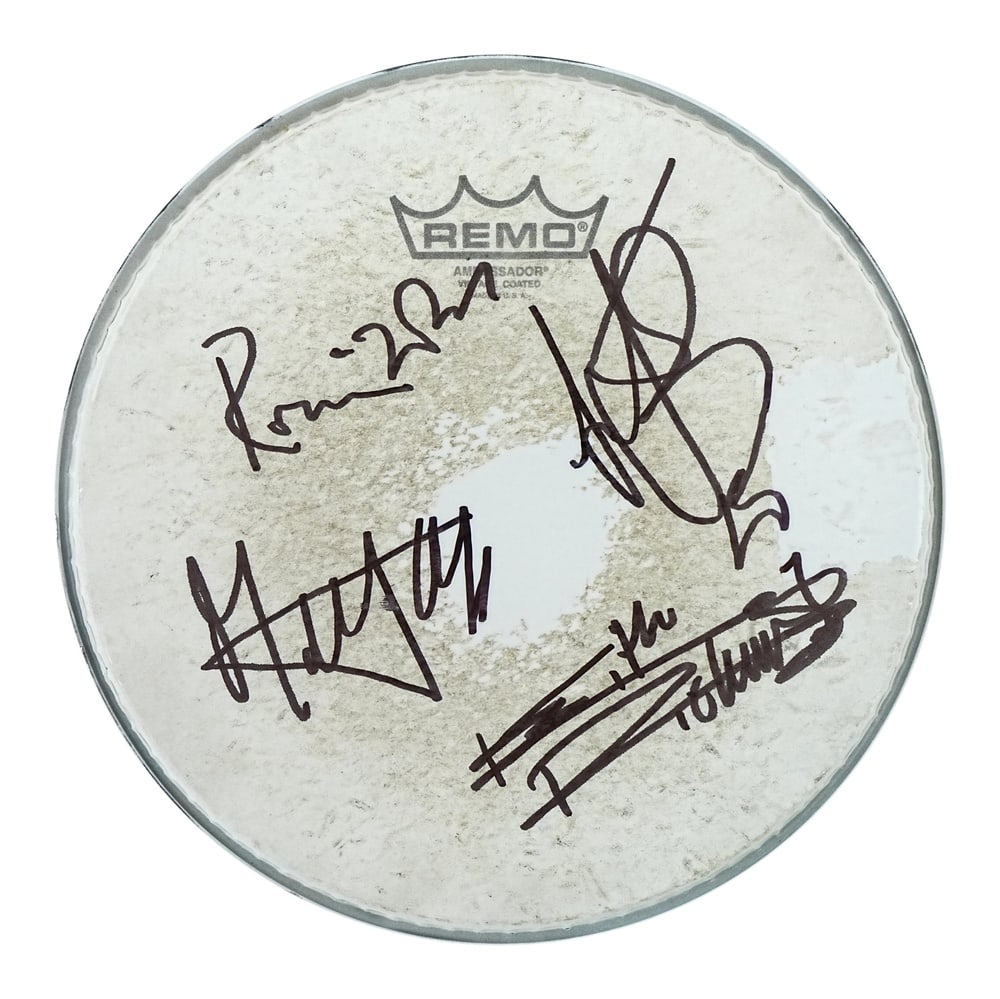 THE ROLLING STONES FULLY SIGNED REMO DRUMHEAD: Diameter 10 1/2 in (26.6 cm) This Remo drumhead has been fully signed by four members of The Rolling Stones, one of the most enduring and influential rock bands in history. Executed in black ink, the