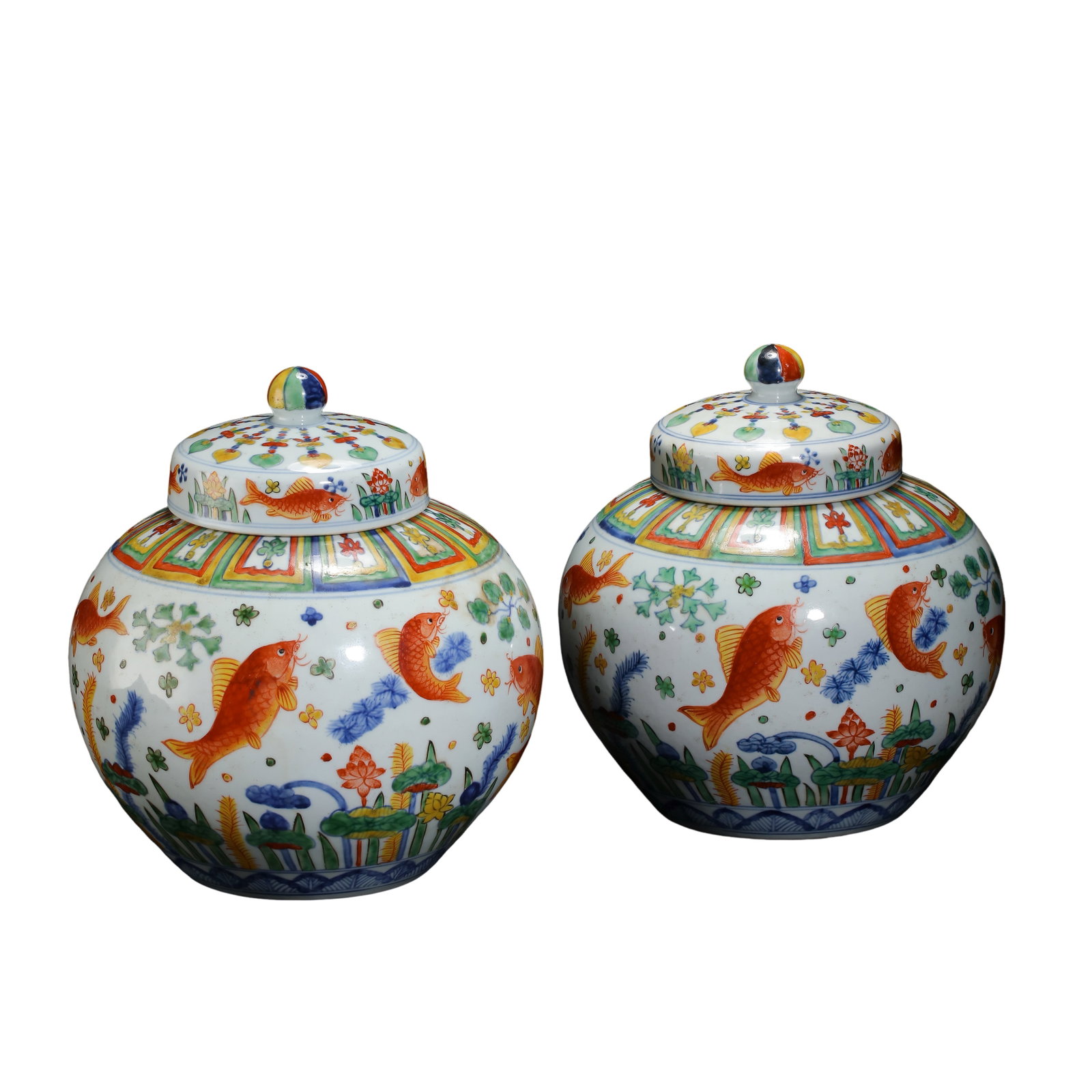 Jiajing Period, Ming Dynasty (1522–1566) Pair of Wucai Fish and Aquatic Plant Covered Jars with: Dimensions: Height 25 cm (9.8 in), mouth diameter 16.5 cm (6.5 in), circa mid-16th Century?Condition & Provenance: The pair is well preserved, with bright glaze, clear polychrome decoration, and natur