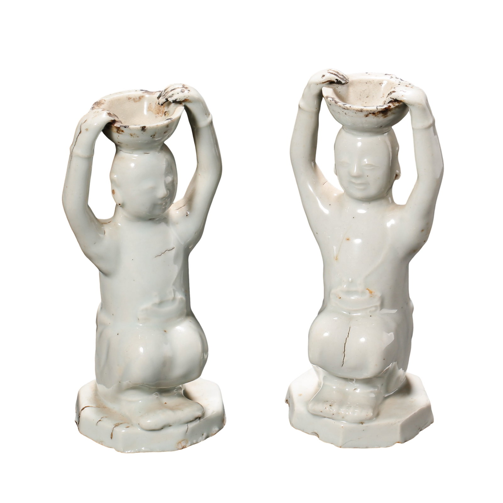 Song Dynasty Hutian Kiln White-Glazed Kneeling Boy Candleholders, A Pair, 12th Century: Dimensions: Each: Height 16 cm (6.30 in); Maximum Width 7.5 cm (2.95 in); Century: 12th Century?Condition & Provenance: Complete as a matching pair. Both figures exhibit minor age-related firing lines