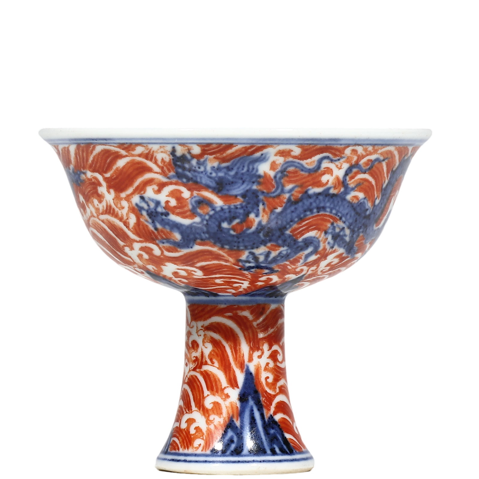 Ming Xuande Period Underglaze?Blue and Iron?Red Stem Bowl with Dragon?and?Sea?Wave Motif: Dimensions?H.8cm?Diam.10cm Condition & Provenance?The bowl is intact, free of cracks and chips. Minor age?related wear at rim. Well?preserved cobalt and iron?red enamels. Foot base bears natural soil 