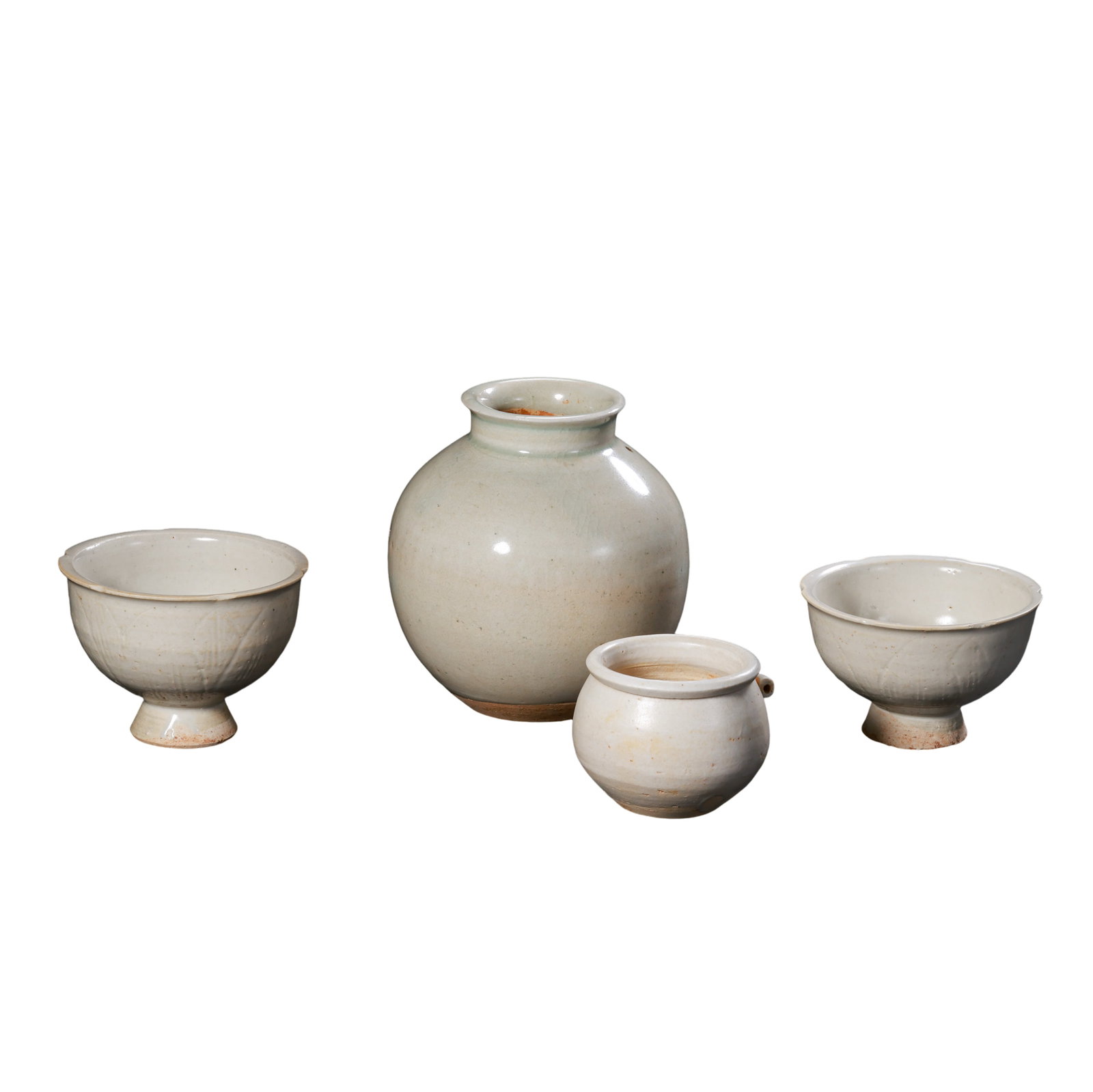 Group of Four Song?Dynasty Bluish?White Porcelains: Pair of Floral?Rim Stem Cups, Small: Dimensions?Large jar mouth diameter 10cm (3.94 in), overall height 10.9cm (4.29 in); small single?handle pot overall height 5cm (1.97 in); stem cup overall height 6cm (2.36 in), 10th?13th Century A.D.