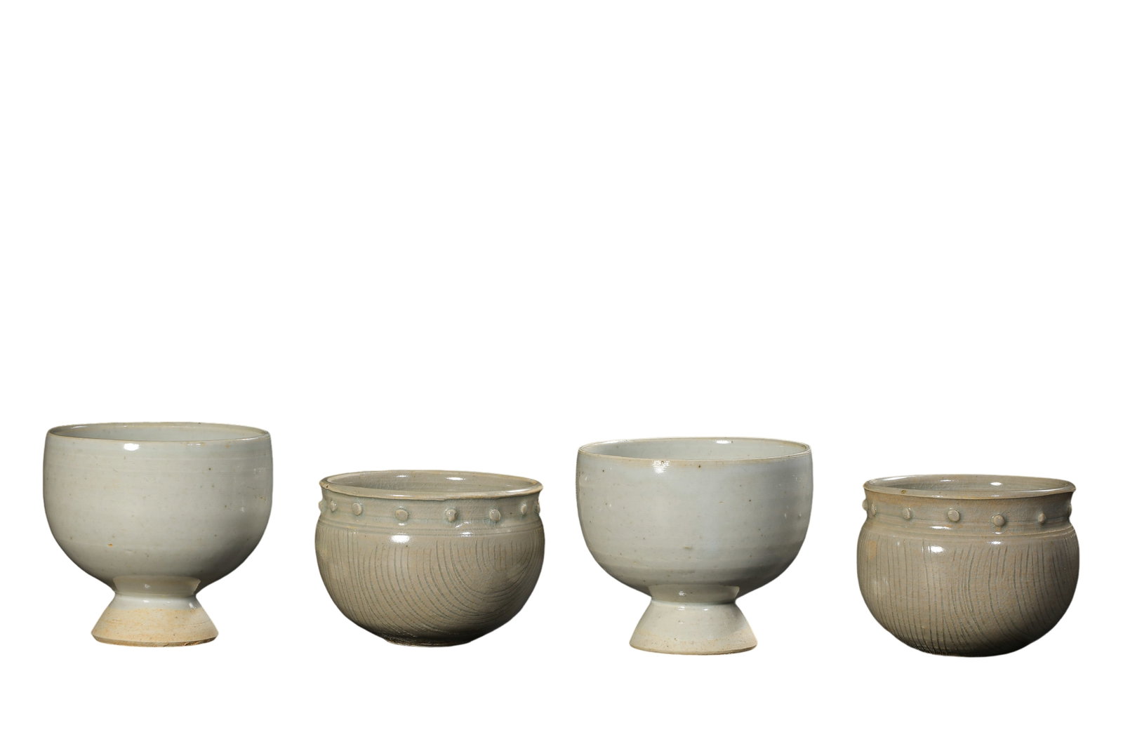 Set of Four Song Dynasty Bluish?White Porcelain Stem Cups and Comb?Mark Studded Jars,10th?13th: Dimensions?Two stem cups: mouth diameter 6.8cm (2.68 in), height 6.2cm (2.44 in); Two comb?mark studded small jars: mouth diameter 6.5cm (2.56 in), height 5cm (1.97 in),10th?13th Century A.D.Condition