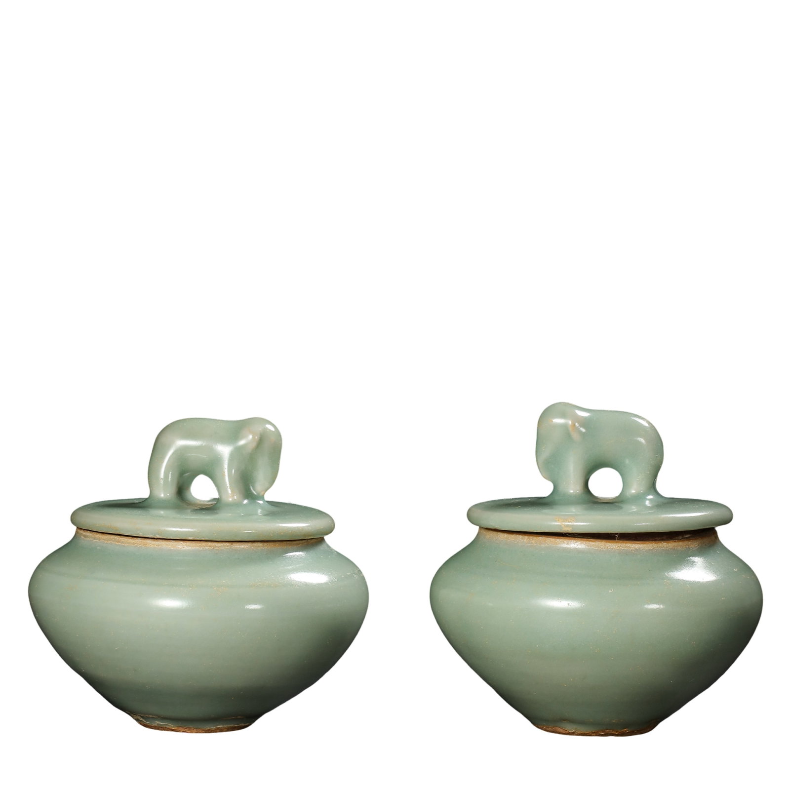Yuan Longquan Kiln Pink?Celadon Elephant?Knob Covered Jars?A Pair?,14th Century CE: Dimensions:One jar height 8.5cm(3.35in),diameter 8.5cm(3.35in);the other jar height 9cm(3.54in),diameter 8.5cm(3.35in),14th Century CECondition & Provenance:The pair is fully intact.Jars,lids and elep
