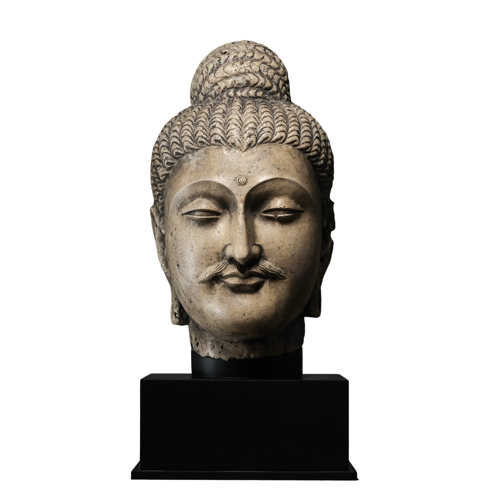 Gandhara Stone?Carved Buddha Head with Custom Modern Display Base: Dimensions?Buddha head height 35 cm (13.8 in), maximum width 22 cm (8.7 in), overall height including base 49 cm (19.3 in), 2nd?4th Century CECondition & Provenance?The stone Buddha head remains large
