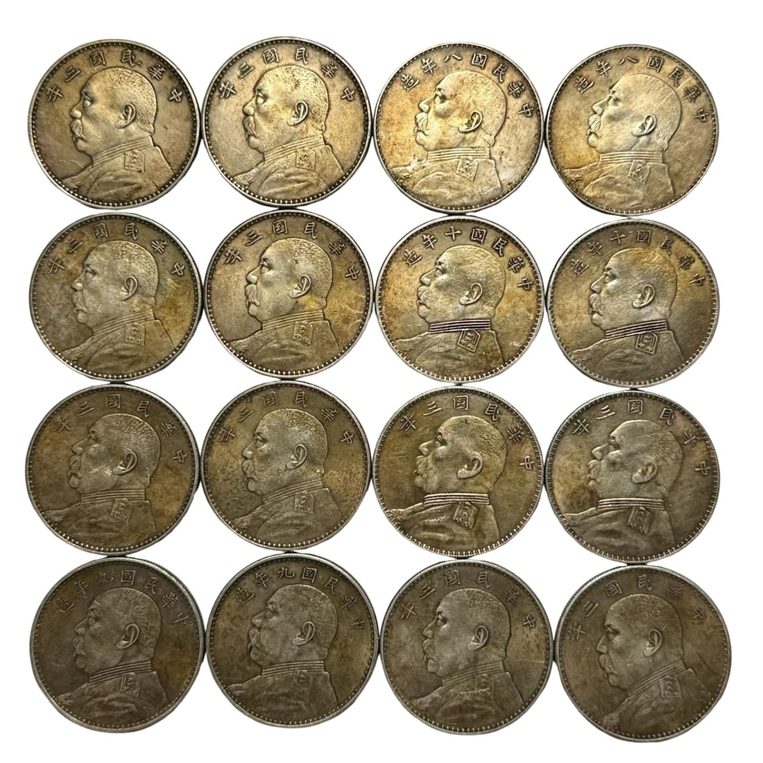 Sixteen Republic of China Yuan Shih?kai One?Dollar Silver Coins: Period?3rd, 8th, 9th, 10th Year of the Republic of China (1914?1921), Early 20th Century Dimensions?Each coin approx. 39mm (1.54 inches in diameter) Condition & Provenance?Original aged toning across 