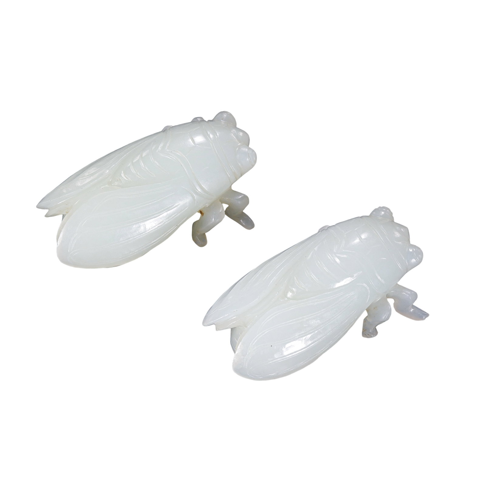 A Pair of Qing?Dynasty White Nephrite Jade Cicada Carvings: Dimensions?Length 4.5 cm (1?49/64 in), Width 2.5 cm (63/64 in), Total Weight 58g; Qing DynastyCondition & Provenance?Both cicadas remain intact, no major chips or repairs. Minor faint wear is visible 