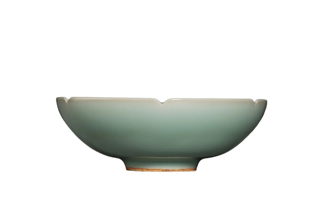 Southern Song Dynasty,Longquan Celadon Lobed Bowl with Molded Turtle Motif: /Condition & Provenance?The bowl is largely intact.The glaze maintains lustrous surface with natural aged patina.The lobed rim bears tiny old chips.Foot ring shows natural earth staining and faint