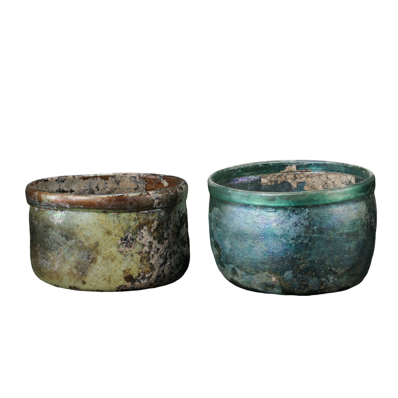 Pair of Ancient Iridescent Glass Cups, Han?Tang Period: Dimensions:First cup: Diameter 8cm (3?1/8in), Height 5.2cm (2?1/16in); Second cup: Diameter 8cm (3?1/8in), Height 4.7cm (1?7/8in)Condition & Provenance:Here we’ve got this matching pair of ancient g