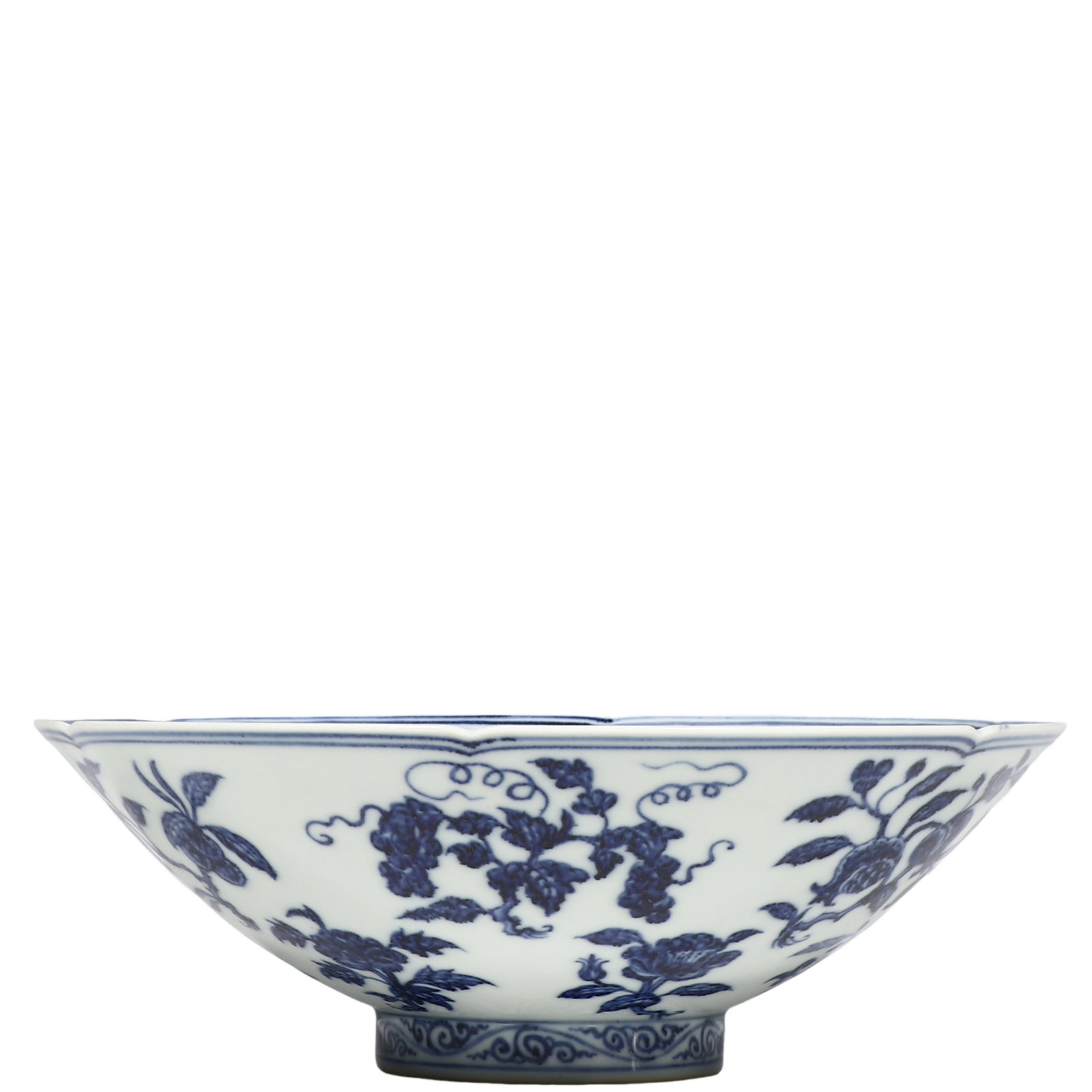Ming Xuande Blue?and?White Floral?Fruit Foliate?Rim Conical Bowl,Ming Dynasty,Xuande Period: Dimensions?H.0.249 ft.?Diam.0.722 ft.?H.7.6 cm?Diam.22 cm? Condition & Provenance?The bowl is fully intact,free of cracks,hairlines and restorations,the foliate rim only bears faint age?related surfac
