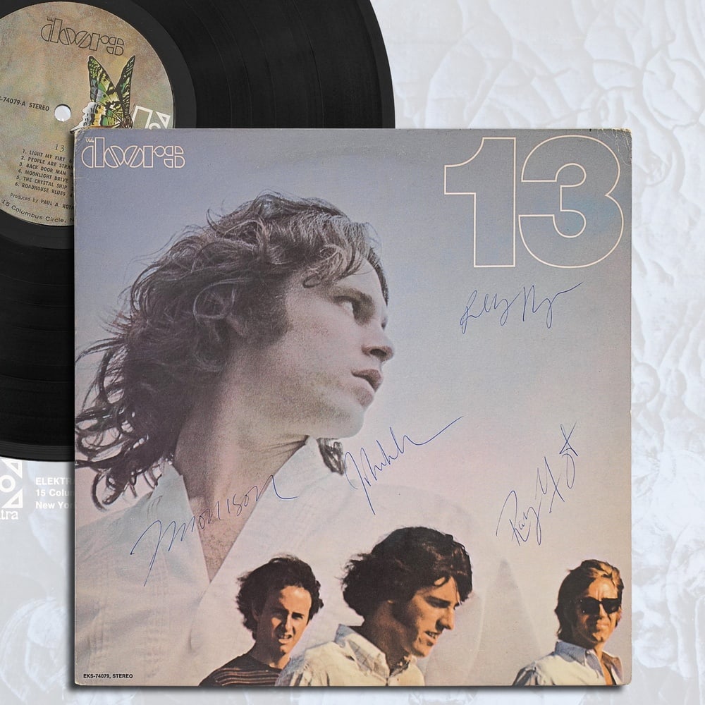 THE DOORS FULLY SIGNED "13" LP: 12 3/8 x 12 3/8 in (31.5 x 31.5 cm) Provenance and Authentication: According to the Letter of Authenticity (LOA) and Certificate of Authenticity (COA) provided by the consignor, this collectible was
