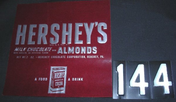 Bar Wrapper- HERSHEY'S MILK CHOCOLATE with Almond: Bar Wrapper- "HERSHEY'S MILK CHOCOLATE with Almonds". 2 oz. Hershey's Breakfast Cocoa logo included. "A Food - A Drink".