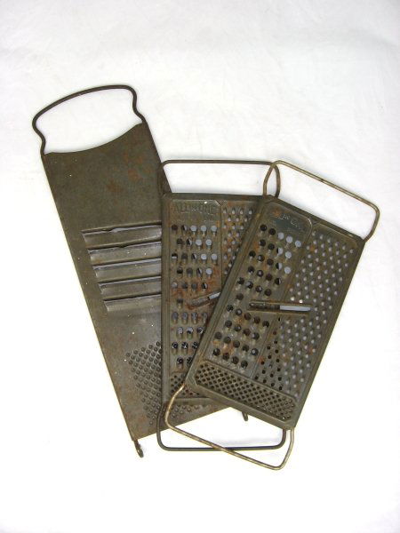 3 Early 1900's Tin Food Graters: 37. 3 Early Tin Food Graters, 2 Embossed "All in One" ; 10 1/2" t. & 14" t.; Good - Some Rust