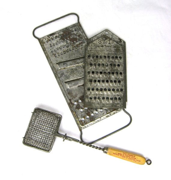3 Early Tin Food Graters & Soap Saver: 38. 3 Early Tin Food Graters & Soap Saver - 2 Embossed "3 in 1" Lightning Shredder - The Family Wine & Liquor Store - 125 Washington St Binghamton ; 6 3/4" t., 12" t., 10 1/2" l.; Good - Minor Age Wea