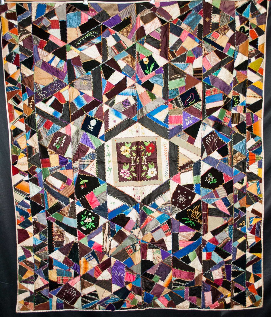 ANTIQUE CRAZY QUILT DATED 1888, HAND MADE: ANTIQUE DATED 1888 CRAZY QUILT HAND MADE HEAVILY EMBROIDERED 68" X 57" A masterpiece of Victorian embroidery and floral raised work. This turn of the century crazy quilt reminds me of a Picasso abstra