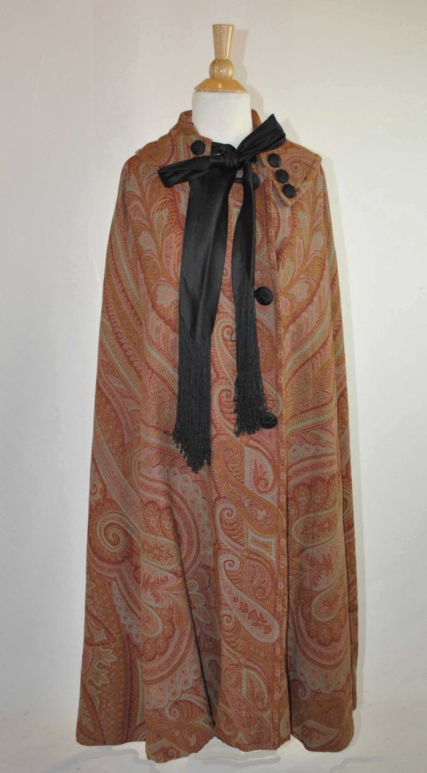EDWARDIAN PAISLEY EVENING CLOAK, c1915: EDWARDIAN PAISLEY EVENING CLOAK, c1915 Edwardian wool paisley evening cloak with black satin lining and two black satin streamers. Full puff sleeves. Fancy black satin fabric covered buttons. No label