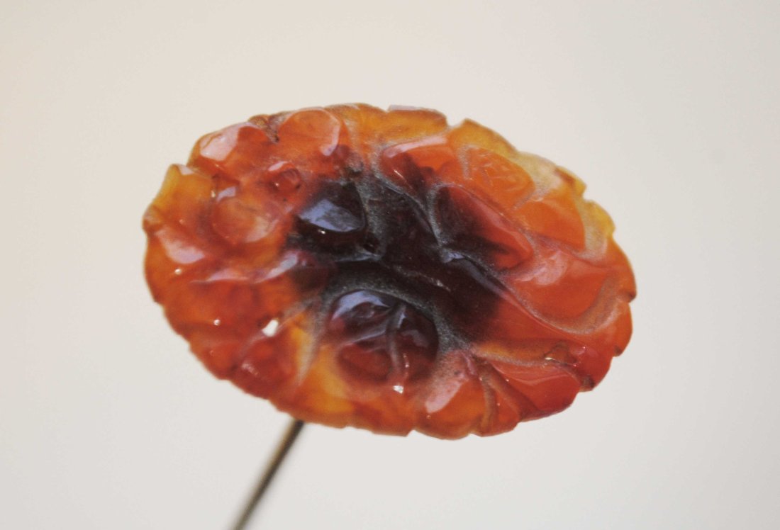 ANTIQUE HATPIN WITH AMBER COLORED GLASS OBLONG HEAD: ANTIQUE HATPIN WITH AMBER COLORED GLASS OBLONG HEAD An original 19th century hatpin that is comprised with a nice sized multi faceted amber colored oblong glass head. CONDITION Good condition for its 
