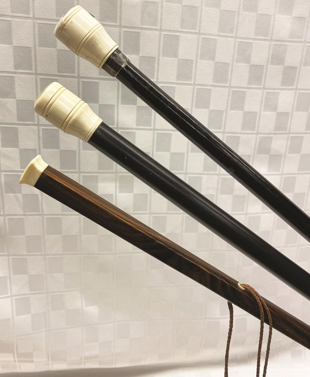 Three Straight Canes, each with a Curved or Turned: Turned Top: One Round Cane contains a Window with Miniature Dice, One Contains a Window with a Trout Fly and One Solid Cap on Rosewood. Codition: All good