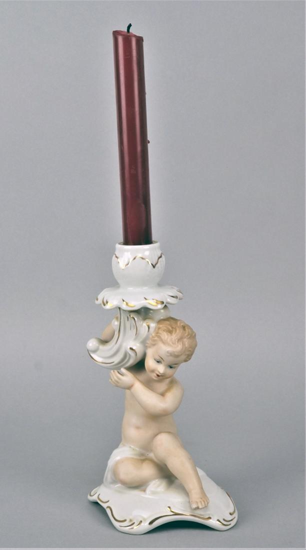 Candlestick angel, 50's: Candlestick angel, 50's Porcelain white and gold glazed, angel skin colored and matt, holding the candleholder above the head. On the bottom green manufacturer's mark "Wallendorf". Intact. H. 21cm. Le