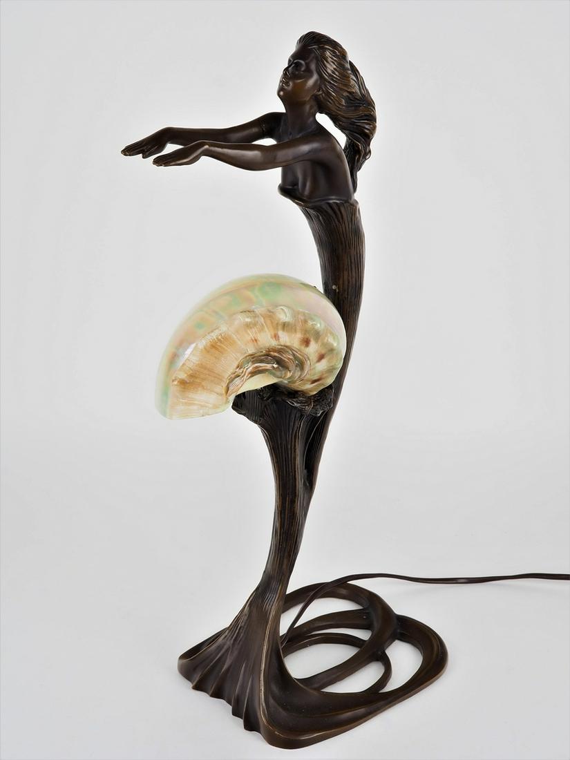Art Nouveau style table lamp: Art Nouveau style table lampLamp base made of bronze, patinated, in the form of a female figure with outstretched arms and waving hair. openwork stand. In the center burning point E14. With shade in t