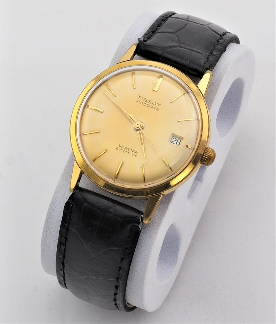 Men's wrist watch Tissot, 70s.: Men's wrist watch Tissot, 70s.Gold plated steel case, beige dial with index numbers, center second hand and date display at the three. Automatic movement. Dial marked "Tissot Visodate" and "Seastar Au
