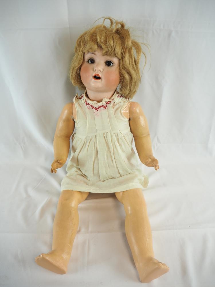 Large Doll with a porcelain head, around 1900: Large Doll with a porcelain head, around 1900Sleepy eyes, open mouth with two teeth. Manufacturer's sign "S.Q.-12- SchÃ¼tzenmeister + Quendt" on the reverse. Mass body with moving hands and legs. Si