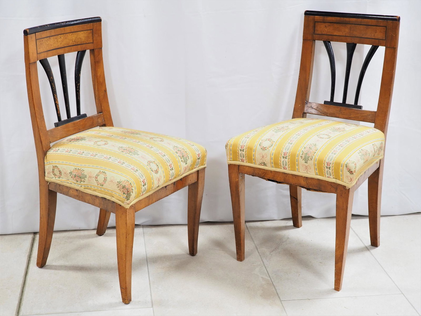 Pair of Biedermeier chairs, southern Germany around: Pair of Biedermeier chairs, southern Germany around 1810 Made of light walnut, partly solid and partly veneered. Slightly molded back, shoulder back slightly bent as well as veneered with root wood fi