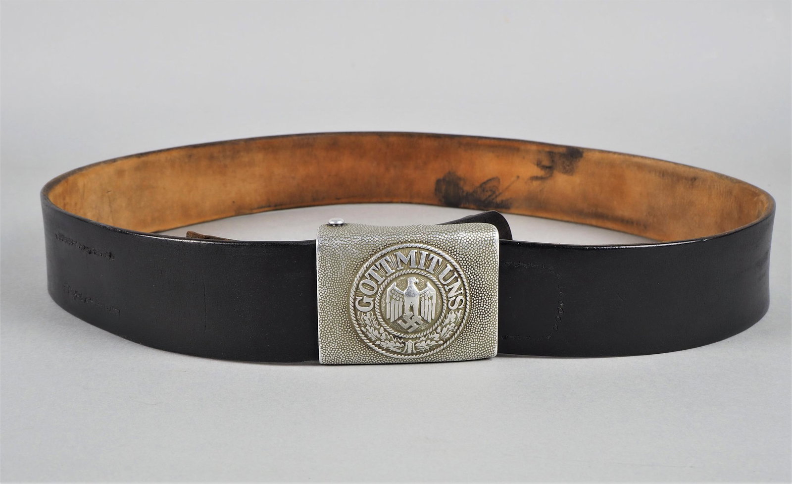 Wehrmacht belt buckle with original leather strap, 1937.: Wehrmacht belt buckle with original leather strap, 1937. National Socialist German Reich, aluminum belt buckle with sovereignty eagle and swastika and motto "GOTT MIT UNS". Leather sling with manufact