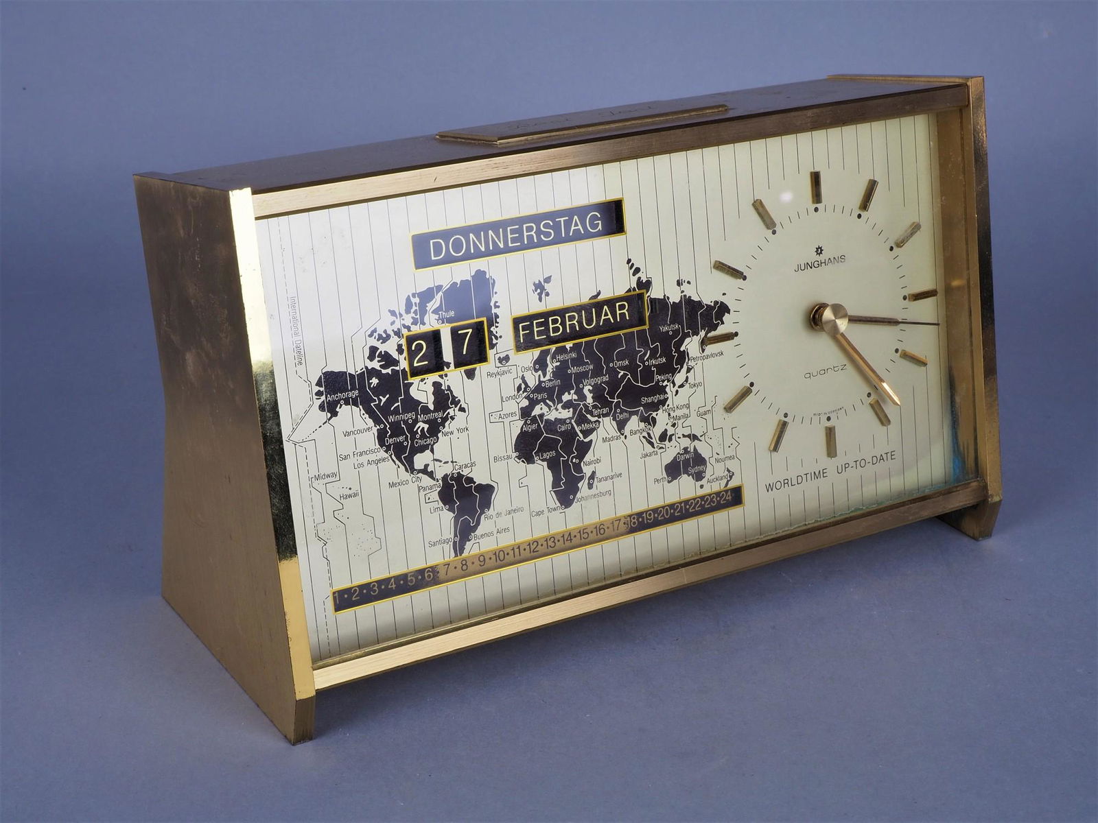 Junghans "Worldtime": Junghans "Worldtime" Table clock in heavy brass case with glazed front, back with small door. Clock with calendar and center second hand, quartz movement circa 70's, not tested for rate, good optical