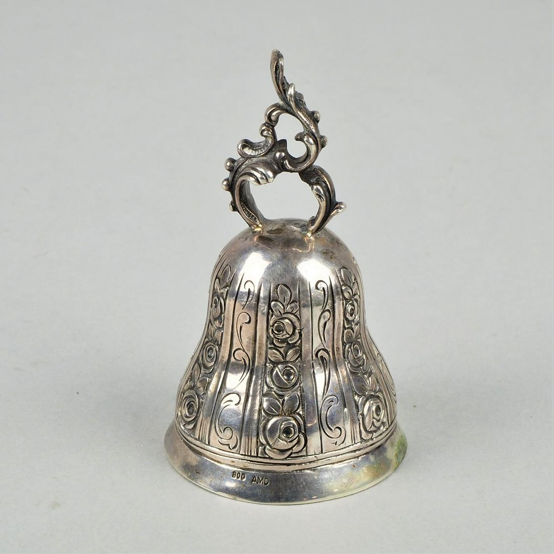 AMD, silver table bell, around 1900: AMD, silver table bell, around 1900Very finely crafted table bell made of 800 silver, top set with chased rose decor, clapper and handle in the shape of a rocaille. Marked. Dimensions: h. ca. 8,5 cm, 