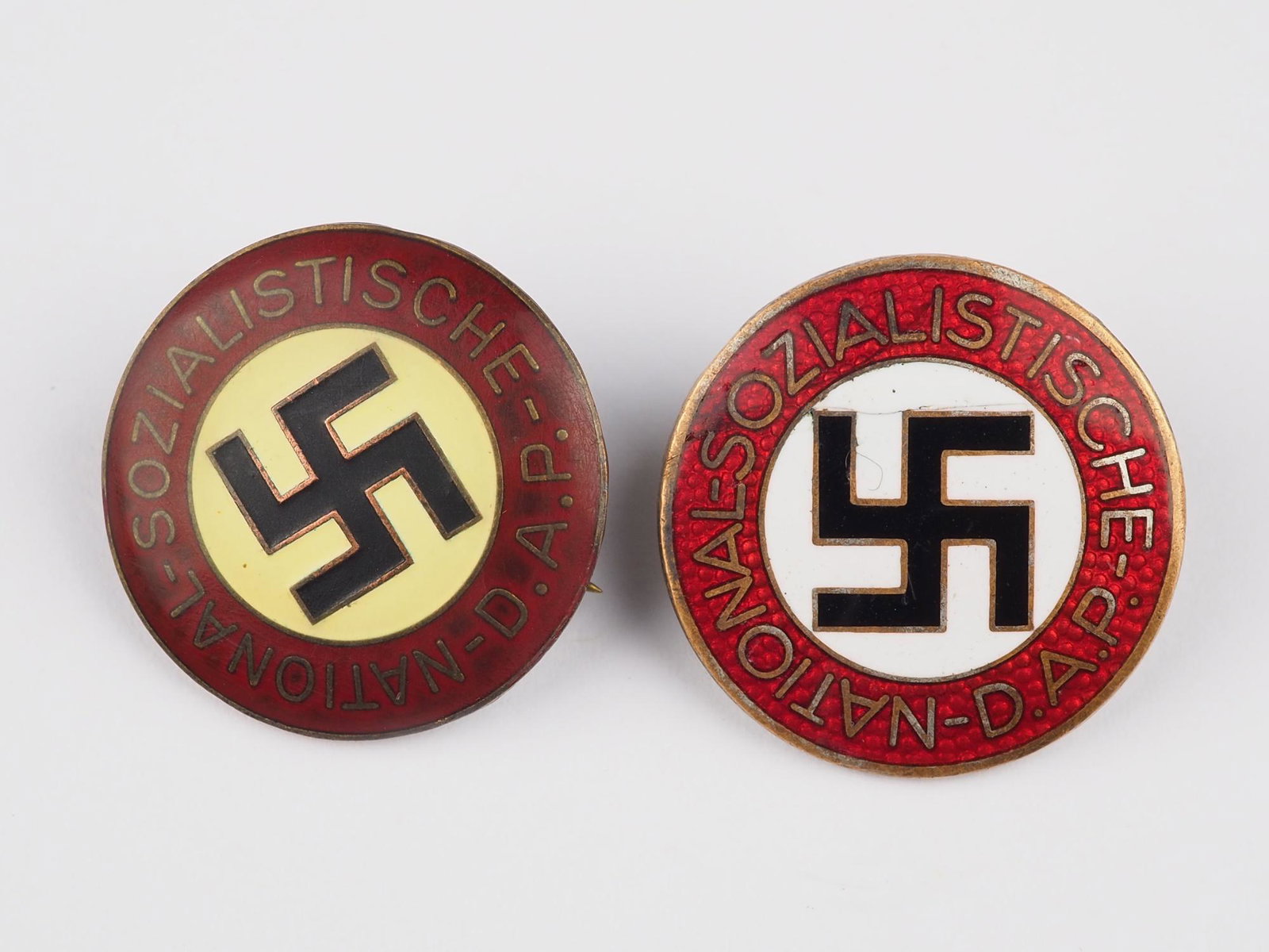 2 NSDAP party badges: 2 NSDAP party badgesThird Reich badge: 1x maker RZM M1/77 = Foerster & Barth in Pforzheim, pin broken off. Once without maker. Ø approx. 23mm2 NSDAP Parteiabzeichen1x Hersteller RZM M1/77 = Foers